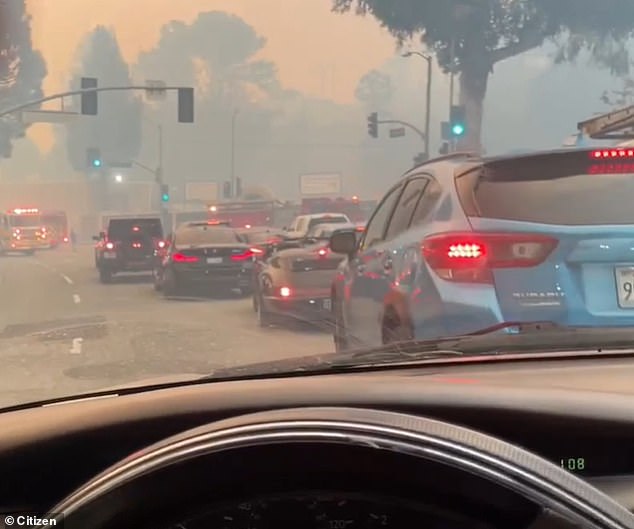 The evacuation notice has caused a gridlock on Sunset Boulevard as LA residents flee, leaving behind their mansions as the 200-acre fire quickly scorches the ground around them.