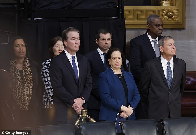 Chief Justice John Roberts, Justices Brett Kavanaugh and Elena Kagan, Transportation Secretary Pete Buttigieg, Defense Secretary Lloyd Austin, and Washington, D.C. Mayor Muriel Browser, at the ceremony honoring the Former President Carter at the United States Capitol.