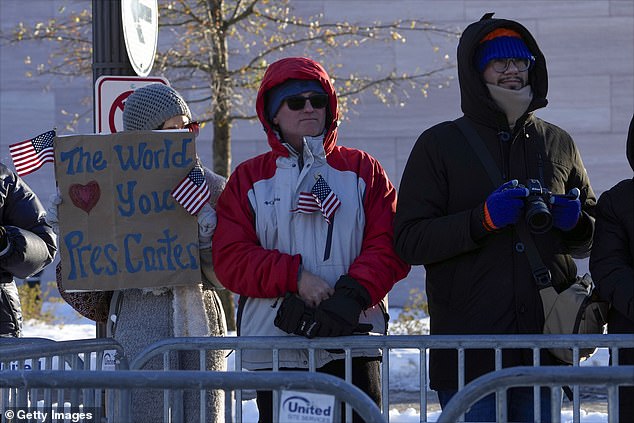 People watch as former President Jimmy Carter's casket passes through Washington to the US Capitol on January 7.