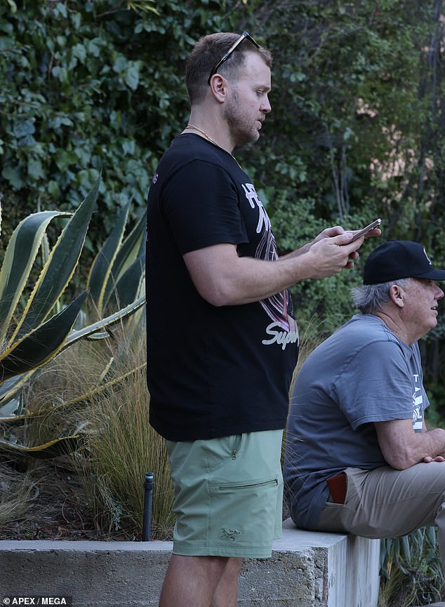 Spencer was filmed looking grim and watching the fire progress with a man who appeared to be his father.