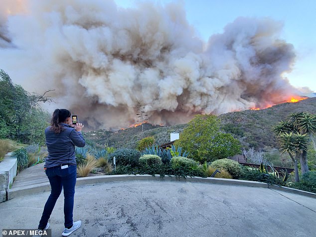 The Hills star, who was wearing a black graphic T-shirt, olive shorts and black sneakers, grazed her eyes at one point, possibly from irritating smoke or flying debris.