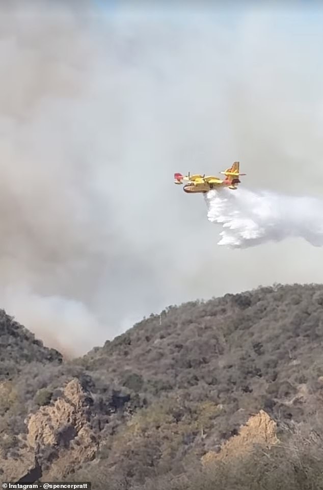 He filmed a plane dropping water on a nearby mountain to try to slow the fire's movement.