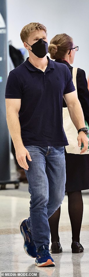 Masked upon his arrival, Robert dressed casually in relaxed blue jeans and a navy polo shirt.