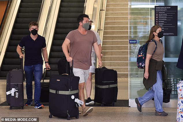 The group rolled several suitcases through the terminal.