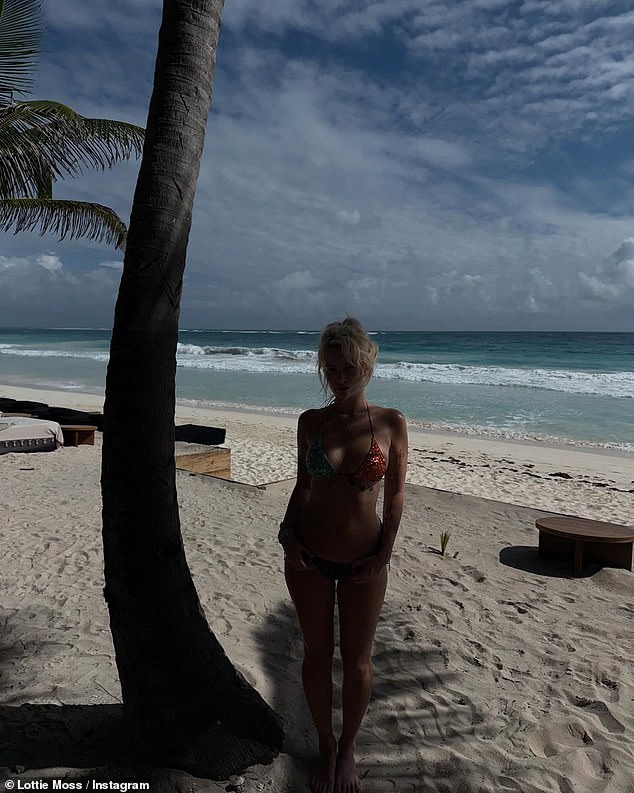 The beauty posed up a storm next to a palm tree on the beach as she flaunted her curves in the stunning two-piece.