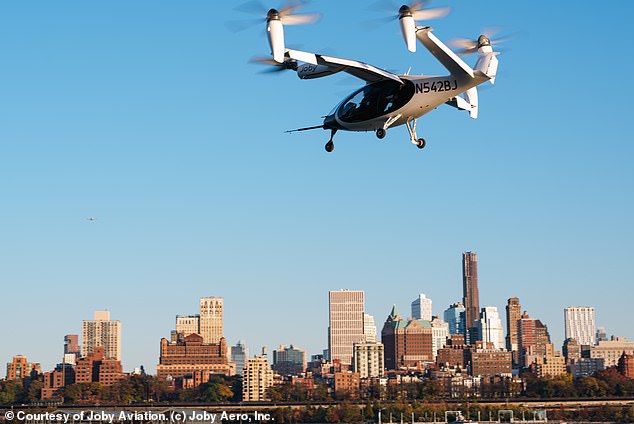 A flying, self-driving robotaxi developed by Joby (pictured) will be used to transport people around the futuristic city