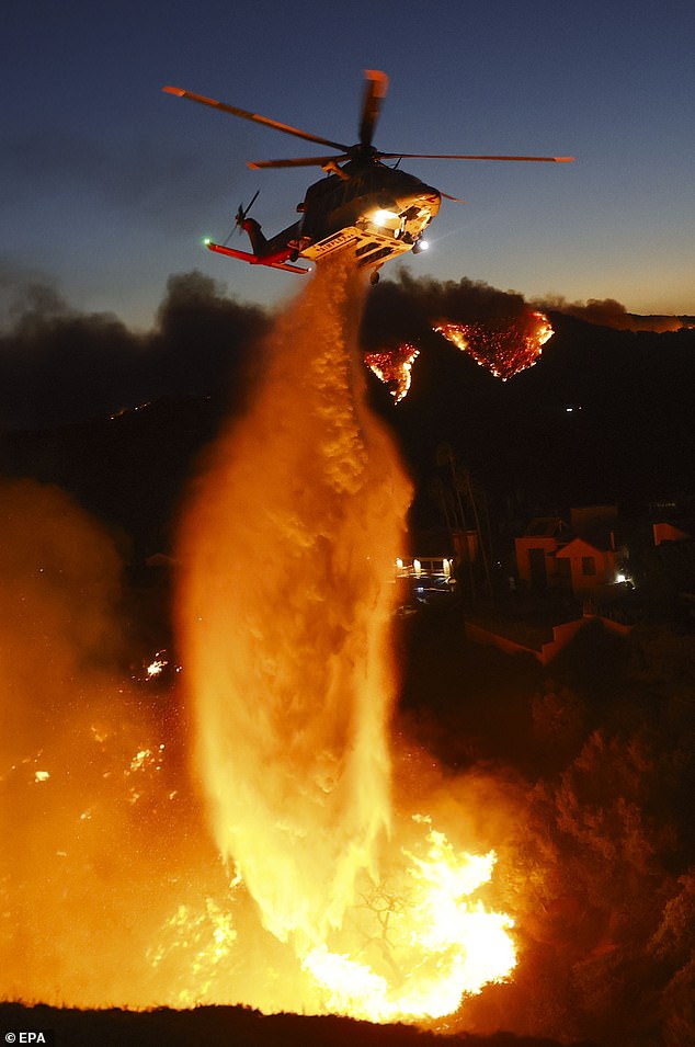 Tankers full of water have been dousing the inferno from the sky all afternoon, but all aircraft are now grounded amid deteriorating wind conditions and visibility.