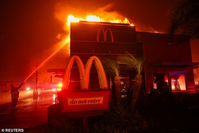 Firefighters attempt to extinguish flames as the Eaton Fire burns in Pasadena, California, USA on January 7