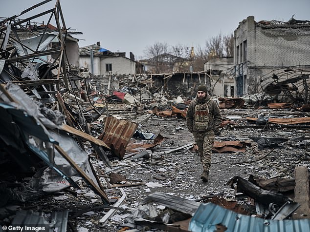 A soldier walks in a ruined central market near the front lines in Ukraine