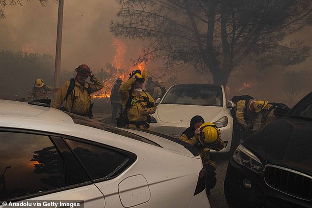 Torrance firefighters are seen preparing to battle the Palisades Fire. Strong winds have made fighting the fires difficult