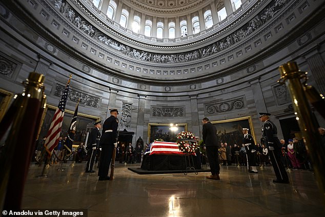 People pay their respects to former US President Jimmy Carter as his flag-draped casket lies in state at the US Capitol Rotunda in Washington, DC on January 8, 2025.