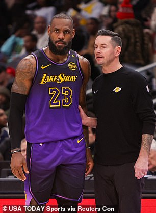 Los Angeles Lakers forward LeBron James (23) talks with head coach JJ Redick against the Atlanta Hawks in the second quarter at State Farm Arena