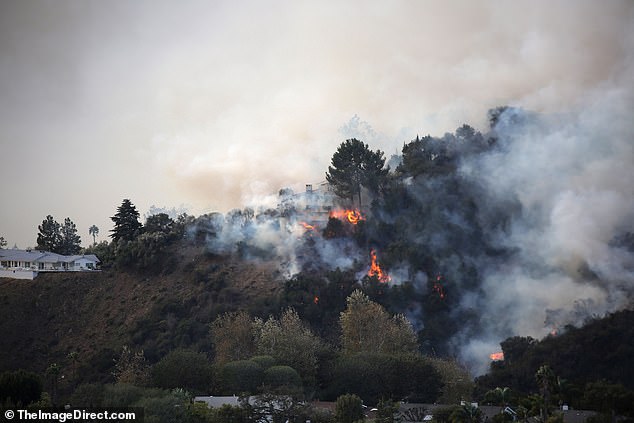 Flames can be seen shooting across the hillside next to another home that appears to be in Fergie's neighborhood.