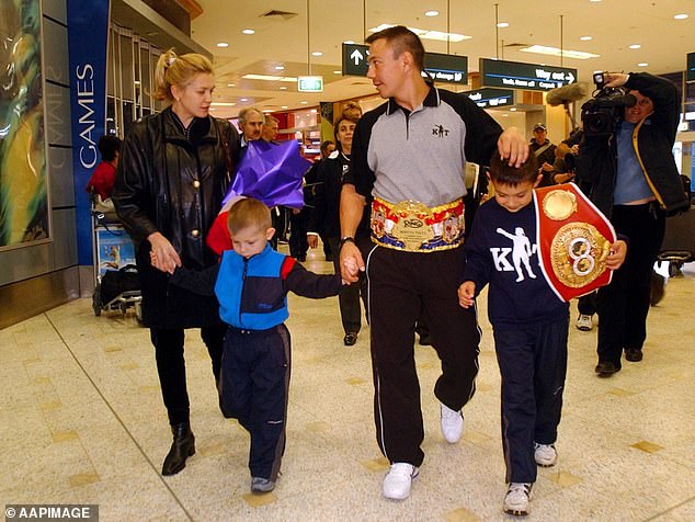 Nikita and Tim are pictured with their father Kostya and mother Natasha in 2002.