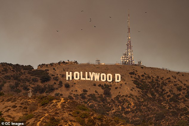 The Hollywood Sign is seen with smoke from multiple wildfires Wednesday in Los Angeles