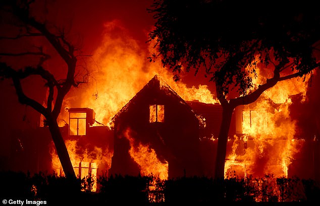 Fires have devastated communities in Pacific Palisades, Pasadena and the Hollywood Hills; A house is seen on fire in Altadena, near Pasadena, on Wednesday