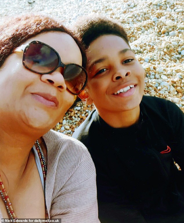 Kelyan is pictured with his mother, Mary, during a trip to the beach as a child.