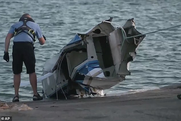 The heartfelt tributes from friends and loved ones come as a long and thorough investigation into the horror crash began (pictured, the wreckage of the plane pulled from the sea on Wednesday).