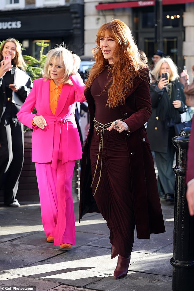 Meanwhile, Twiggy, 75, whose real name is Dame Lesley Lawson, turned heads in a bright pink suit and orange shirt as she posed with the Tilbury team.