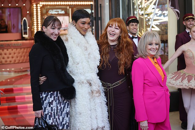 All the women posed together in the front of the store.