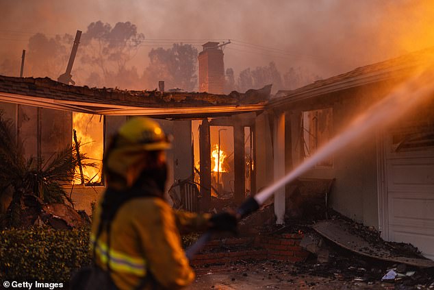 Firefighters battle flames from the Palisades Fire on Jan. 8 in the Pacific Palisades community of Los Angeles.