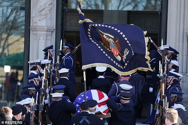 Members of the honor guard carry Jimmy Carter's casket