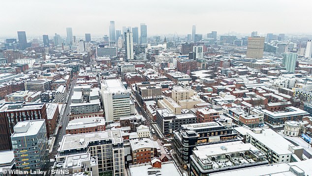 Snow covers Manchester city center this morning as winter weather continues