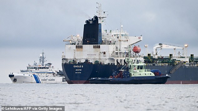 A photo taken on December 28, 2024 off Porkkalanniemi, Kirkkonummi, in the Gulf of Finland, shows the oil tanker Eagle S (C), flying the Cook Islands flag, next to the Finnish border guard ship Uisko (L ) and the tugboat. Ukko (right front)