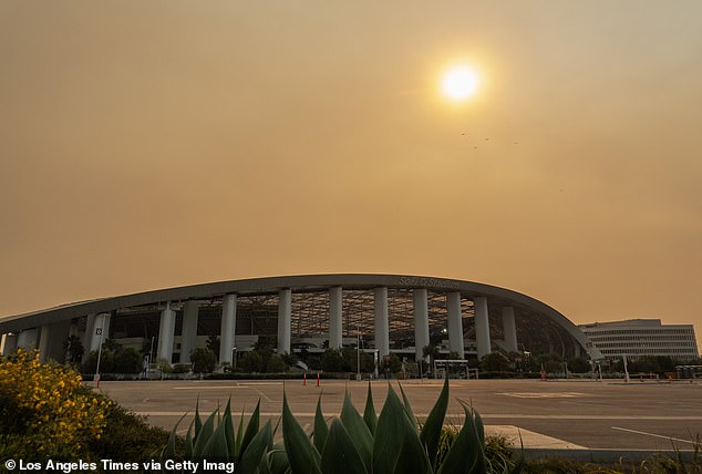 Smoke from recent fires obscures the sun at SoFi Stadium in Inglewood