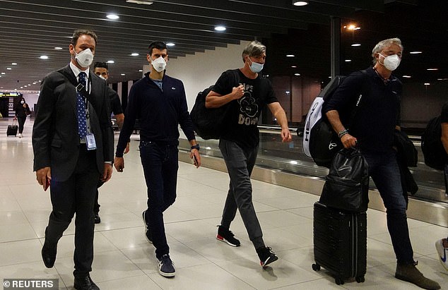 In the photo, the 24-time Grand Slam champion, second from left, is escorted to his flight after Australia's federal court upheld the decision to cancel his visa in 2022.