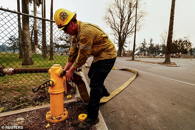 Quiñones said the water tanks, which help fill the fire hydrants, ran out at 3 a.m. local time Wednesday. (Pictured: A firefighter removes a hose from a hydrant after it ran out of water)