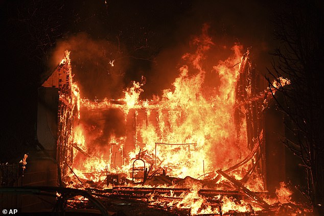 A building is burned by flames in the Pacific Palisades neighborhood of Los Angeles