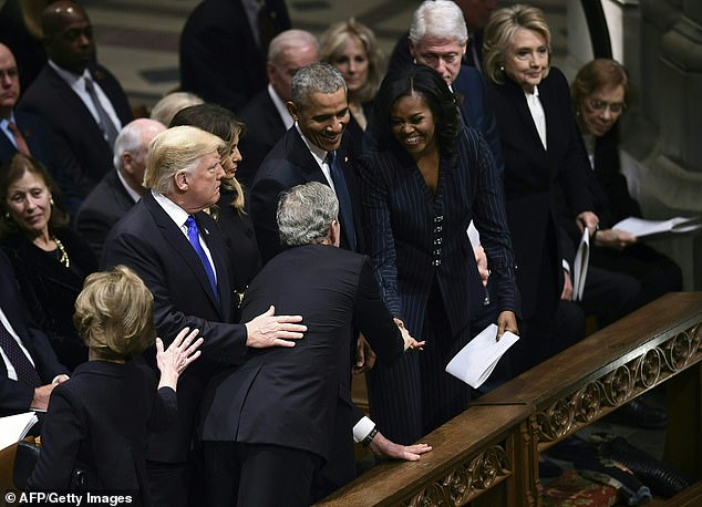 Bush reached past two three people to greet former First Lady Michelle Obama at the funeral of his father, former President George HW Bush in 2018