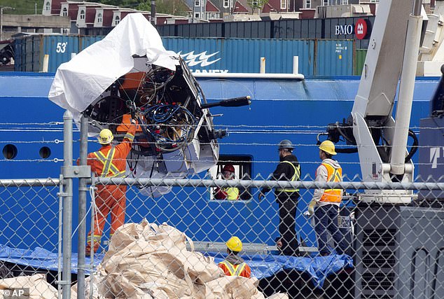 Debris from the Titan submarine, recovered from the ocean floor near the wreck of the Titanic, is offloaded from the ship Horizon Arctic at the Canadian Coast Guard pier in St. John's, Newfoundland