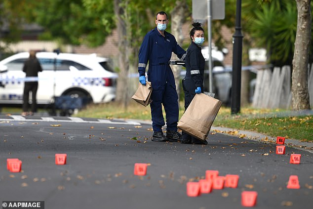 Footage showed the crime scene (pictured) littered with bullet casings over a wide area as detectives examined the scene on Friday morning.