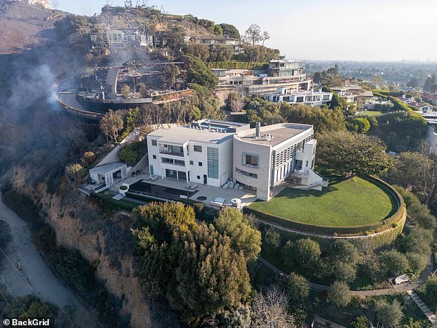 The Pacific Palisades mansion (pictured), which the couple purchased in 2010, narrowly avoided the devastating Los Angeles wildfire that wreaked unimaginable havoc on the beloved celebrity enclave.