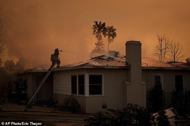 Firefighters battle the Eaton fire as it hits a building on Thursday, January 9, 2025 in Altadena, CA