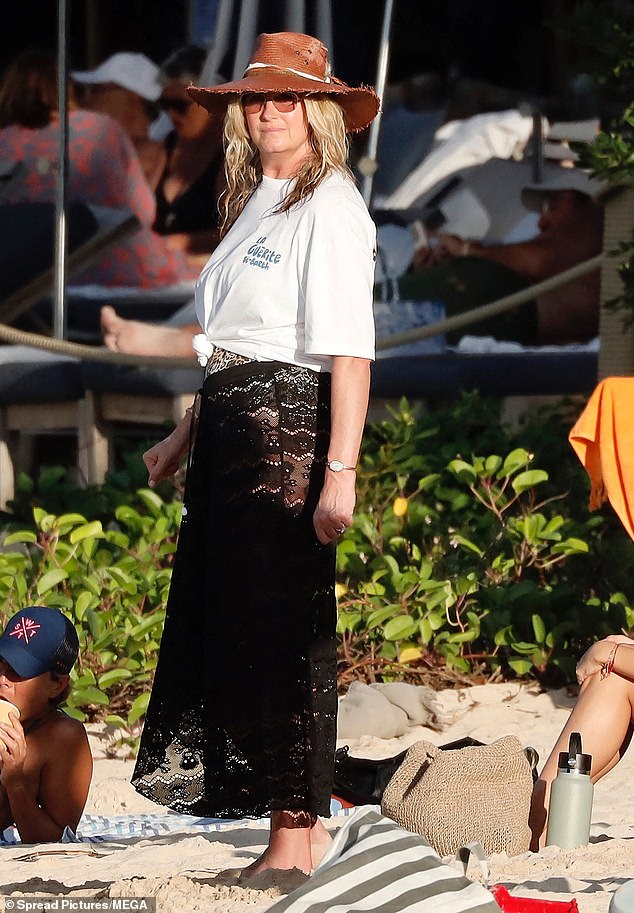 Penny arrived at the beach in a sheer black lace dress and a white t-shirt.