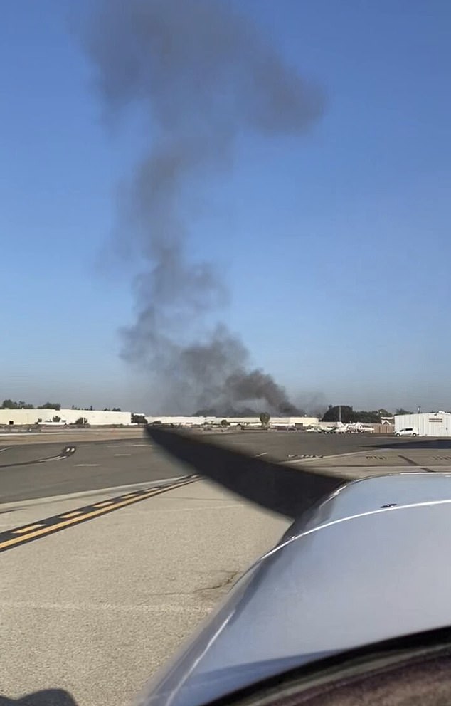 Eleven people were injured Thursday when a small plane crashed into the roof of a commercial building in Southern California, police said. This photo was taken from nearby Fullerton Airport