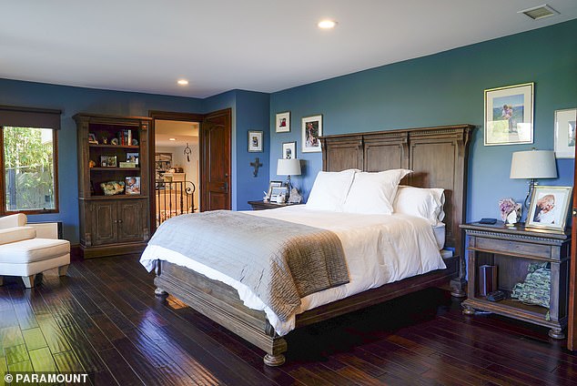 The couple's master bedroom features real oak floors and timeless antique furniture.