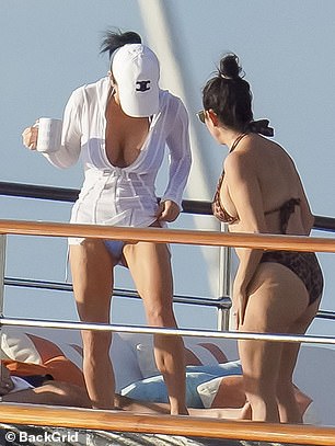 Lauren was wearing a gorgeous white swimsuit with blue pants.