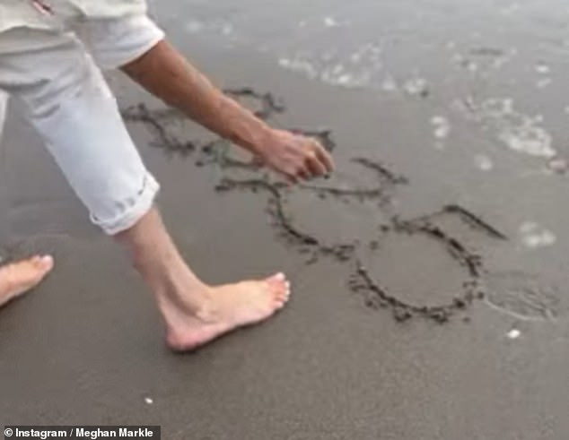 She then wrote '2025' in the sand, before turning and grinning at the camera before running away