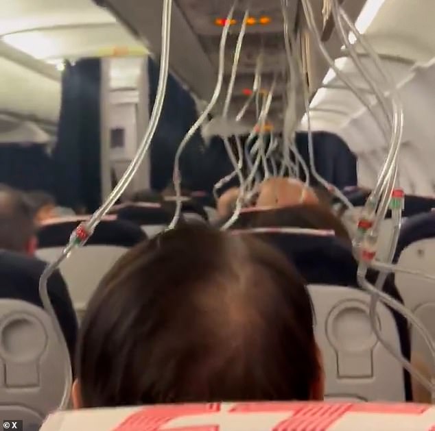 This is the moment oxygen masks fall before an emergency landing in Paris after loss of cabin pressure on an Air France flight