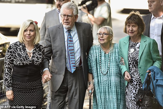 Rolf Harris arrives with his wife Alwen Hughes (second right) and daughter Bindi (left) at Southwark Crown Court in central London on June 30, 2014.