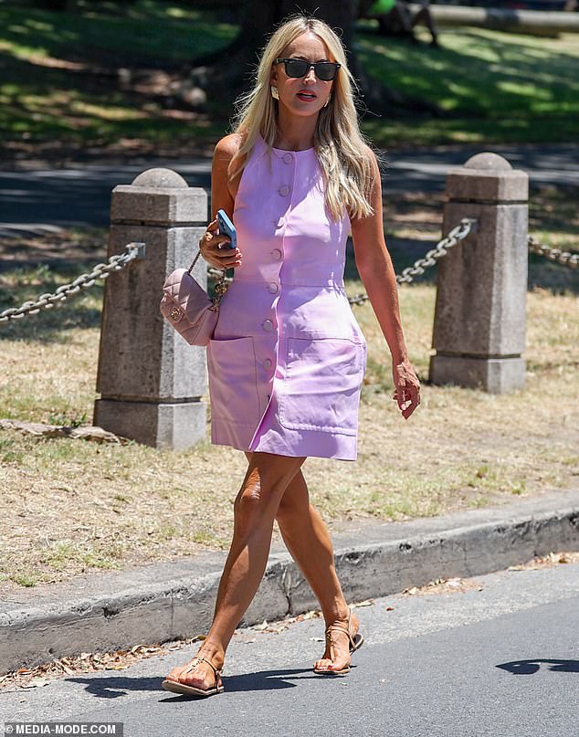 Jackie kept the pink note going by accessorizing with an $8,000 pale pink Chanel mini flap bag, as well as a pair of nude sandals and chunky gold earrings.