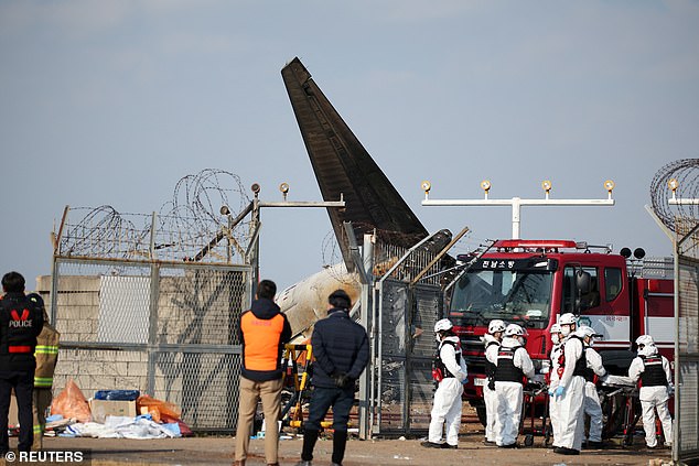 Rescue workers take part in a recovery operation at the site where a plane crashed after going off the runway at Muan International Airport, in Muan, South Korea - December 29, 2024