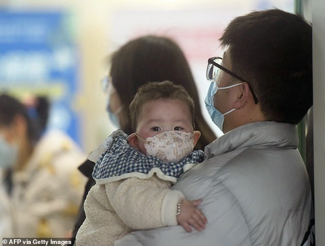 Scenes of hospitals invaded by people wearing masks have circulated on social media. In the photo, a baby wearing a face mask waits with family members in the pediatric department of a hospital in Hangzhou, east China, on January 6.