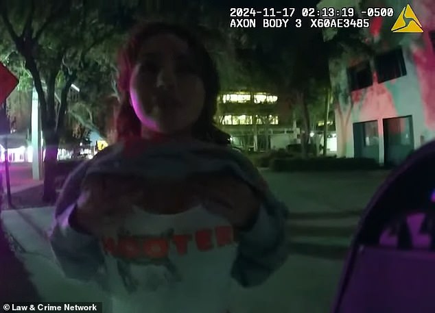 While one of the officers tried to get her to take a field sobriety test, Ross continually flirted with him and at one point even lifted her sweatshirt to reveal her chest (pictured)