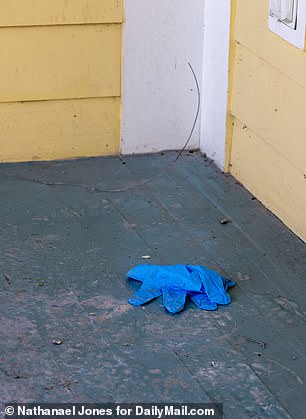 A pair of blue latex gloves were found lying on the porch.