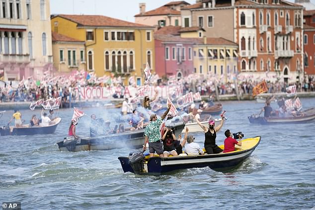 'No Big Ships' activists stage a protest as the MSC Orchestra cruise ship departs Venice, Italy, Saturday, June 5, 2021.